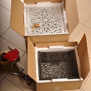 May include: Two open cardboard boxes, one with a white floral design and the other with a black floral design. The boxes are ready to use, fully assembled, and require no glue or tools. Text on the image reads: "Fully assembled box - no glue, no tools required." and "Ready to use right out of the box."