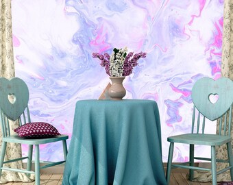 May include: A round table covered with a teal tablecloth sits between two light blue wooden chairs with heart-shaped cutouts in the backrests. A ceramic vase containing purple and white flowers rests on the table against a marbled backdrop.