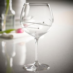May include: A clear glass wine glass with a swirl design and small crystal accents. The glass has a wide bowl and a long stem.