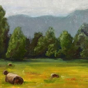 May include: A painting of a field with hay bales in the foreground and a line of trees in the middle ground. The background is a hazy blue mountain range.