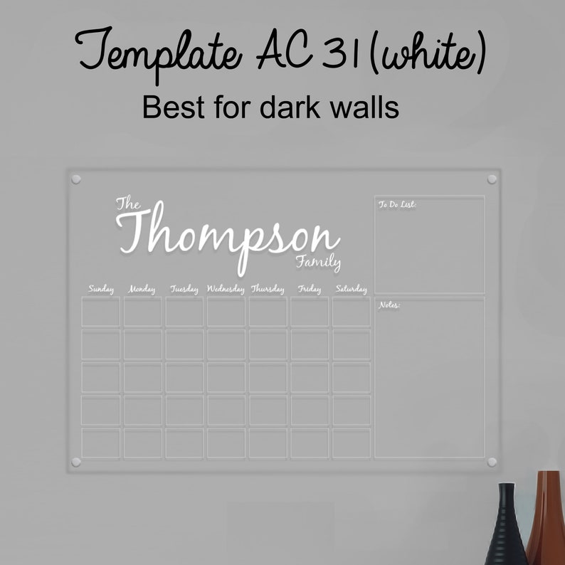 May include: White acrylic dry-erase calendar with a grid for each day of the week, a to-do list section, and a notes section. The calendar has the text "The Thompson Family" at the top.