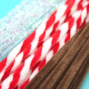 May include: Close-up of several colorful craft supplies. The image features iridescent, red and white striped, and brown pipe cleaners. These fuzzy sticks are often used for DIY projects and crafts.