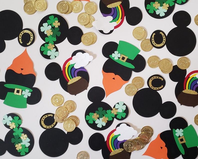 May include: A collection of black and green Mickey Mouse head cutouts with various St. Patrick's Day themed decorations, including shamrocks, rainbows, gold coins, and leprechaun hats.