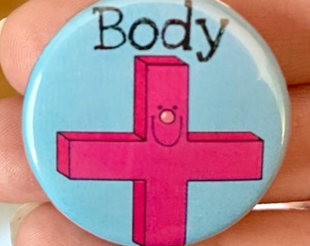 May include: A blue button with the word "Body" printed in black. A pink plus sign with a smiling face is in the centre of the button.