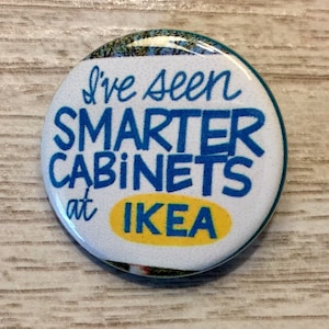 May include: A white button with blue and yellow text that reads "I've seen smarter cabinets at IKEA".