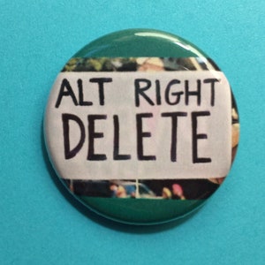 May include: A round button with a green border and a white centre. The text "ALT RIGHT DELETE" is written in black marker on the white centre.