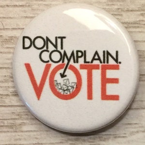 May include: White button with black text that reads "Don't Complain. Vote." An arrow points down to a red circle with a black and white illustration of a ballot box.