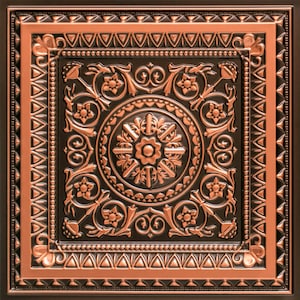 May include: A copper ceiling tile with a black background and an intricate floral design. The tile has a raised, ornate border.