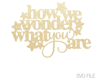 May include: Gold glitter cut-out design with the text "How we wonder what you'll be".
