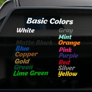 May include: A vinyl decal featuring the text Basic Colors followed by a list of colour options in various hues including white, grey, mint, orange, blue, pink, copper, purple, gold, red, green, silver, lime green, and yellow displayed on a dark surface.
