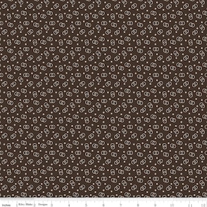 May include: A brown fabric with a repeating pattern of white interlocking circles and small white dots.