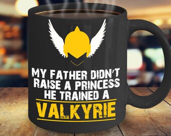 May include: Black coffee mug with a white winged helmet and the text "My father didn't raise a princess he trained a valkyrie".