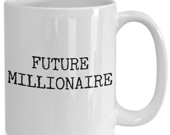 May include: White ceramic coffee mug with black text that reads "FUTURE MILLIONAIRE".
