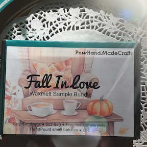 May include: A rectangular box with a teal border and the text "PnwHandMadeCrafts" and "Fall In Love Waxmelt Sample Bundle." The box features an illustration of a cozy scene with a pumpkin, teacups, and a chair. The box contains soy blend wax.