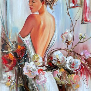 May include: Oil painting of a woman with her back turned, wearing a white dress, surrounded by flowers. The artwork features a palette of warm tones, with red and white flowers. The artist's signature is visible in the bottom right corner, and the text "BILYKART" is in gold.