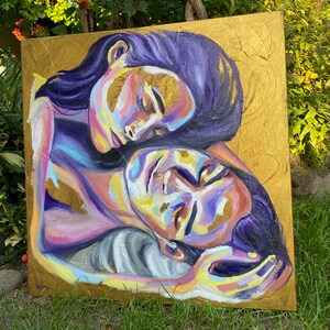May include: A painting of two people embracing. The painting is done in a vibrant style with shades of purple, pink, yellow, and gold. The background is a gold canvas with a textured surface.