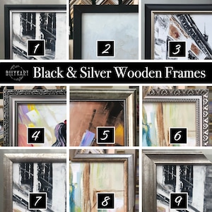 May include: Nine different picture frames with black and silver wooden frames. The frames are arranged in a grid of three rows and three columns. The frames are all different sizes and styles. The frames are all empty.