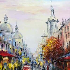May include: Oil painting of a European city street scene. The artwork depicts buildings with domed roofs and a red awning. A red car is driving down the street, and people are walking on the sidewalks. The color palette includes blues, yellows, and reds.