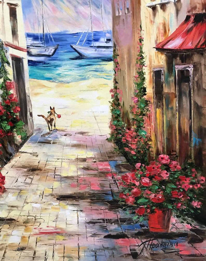 May include: Oil painting of a coastal alleyway with a dog carrying a red object. The scene includes buildings with red flowers, a red roof, and sailboats on the turquoise sea. The artwork has a textured, impressionistic style.