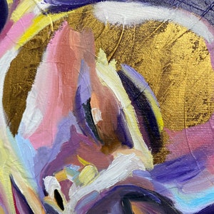 May include: Close-up of an abstract painting with a palette of colors including gold, purple, pink, and yellow. The artwork features thick brushstrokes and a textured surface, creating a dynamic and expressive composition.