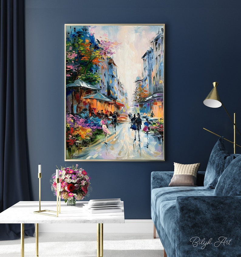 May include: A colorful oil painting depicting a Parisian street scene with buildings, trees, and people walking. The painting has a bright, impressionistic style and features a vibrant palette of colors.
