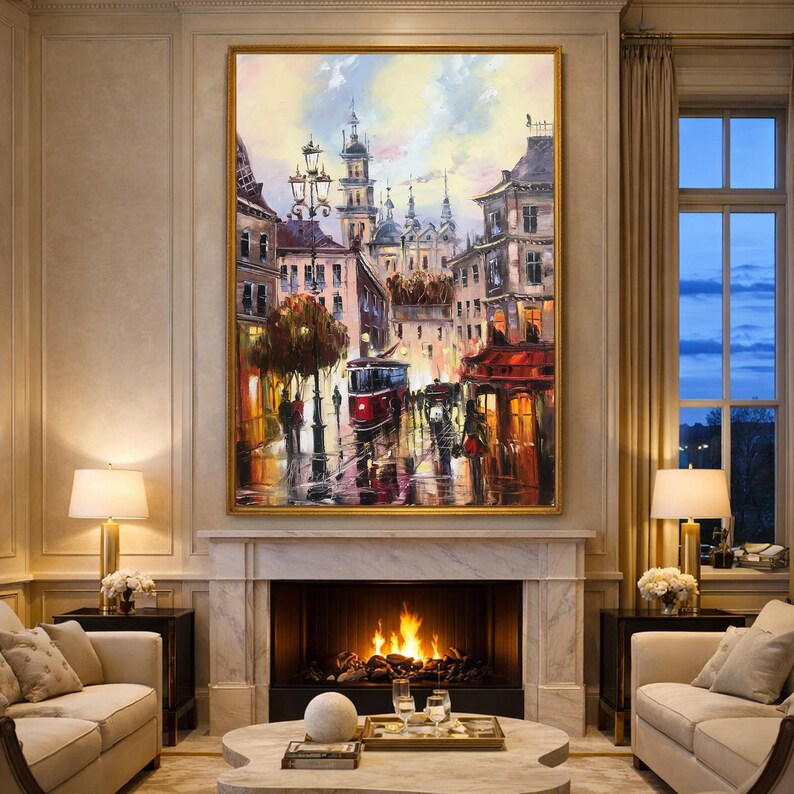 May include: An oil painting depicting a European city street scene. The artwork shows buildings, a red tram, and figures walking on a wet street. The painting is framed in gold and hangs above a fireplace in a living room.