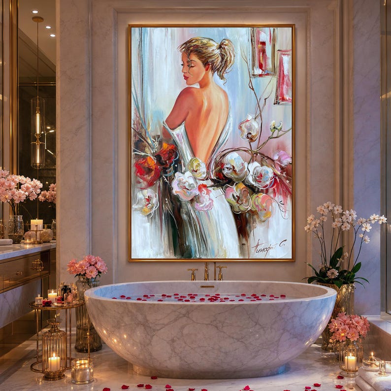 May include: An oil painting of a woman in a white dress with her back to the viewer, surrounded by colorful flowers. The artwork is in a gold frame and hangs above a marble bathtub filled with rose petals.