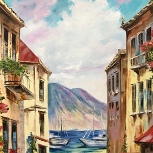 May include: Oil painting of a coastal scene with buildings on either side of a view of the sea. Two sailboats are on the water, with mountains in the background. The sky is blue with white and pink clouds. Red flowers and green plants adorn the buildings.