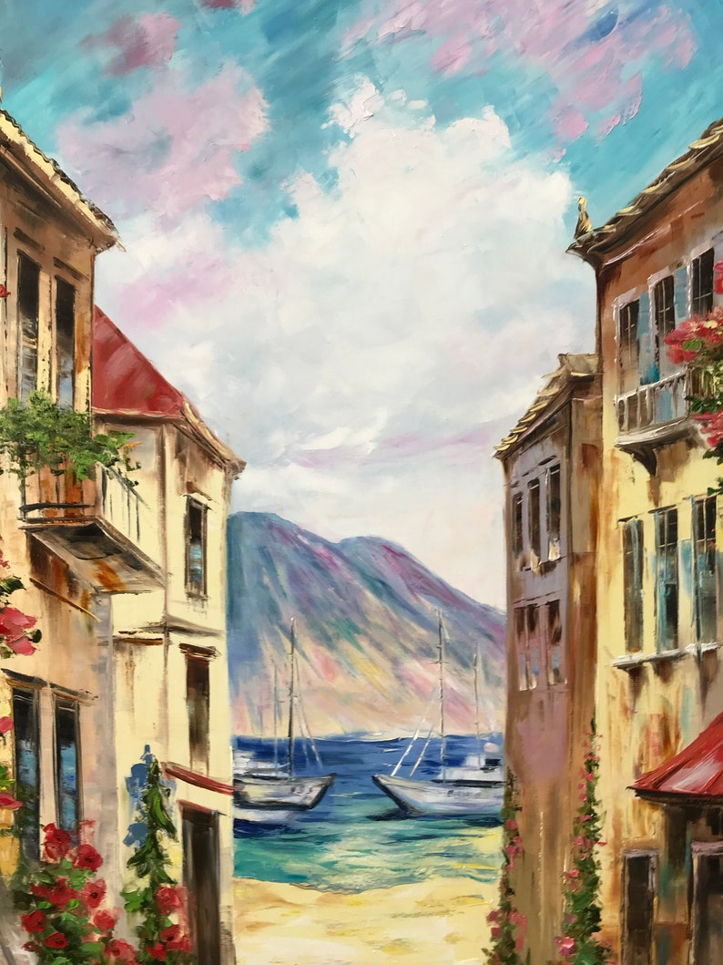May include: Oil painting of a coastal scene with buildings on either side of a view of the sea. Two sailboats are on the water, with mountains in the background. The sky is blue with white and pink clouds. Red flowers and green plants adorn the buildings.