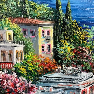 May include: A painting of a colorful seaside town with buildings, trees, and a blue ocean in the background.