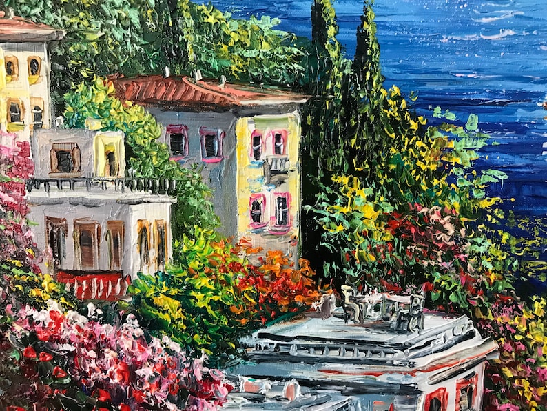 May include: A painting of a colorful seaside town with buildings, trees, and a blue ocean in the background.