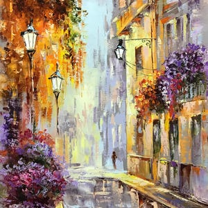 May include: An impressionistic oil painting of a European street scene. The artwork features a narrow street with buildings on either side, adorned with hanging flowers and street lamps. The color palette includes warm yellows, oranges, and purples.
