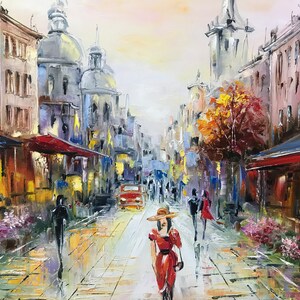 May include: Oil painting of a European city street scene. A woman in a red dress and hat walks toward the viewer. Buildings line the street, and a red car is visible. The artwork uses a palette of blues, yellows, and reds.
