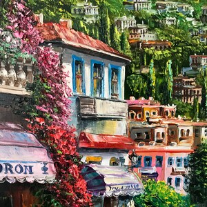 May include: A painting of a colorful, European-style street scene with a cafe awning that reads "FIORON". The cafe is surrounded by lush greenery and colorful buildings.