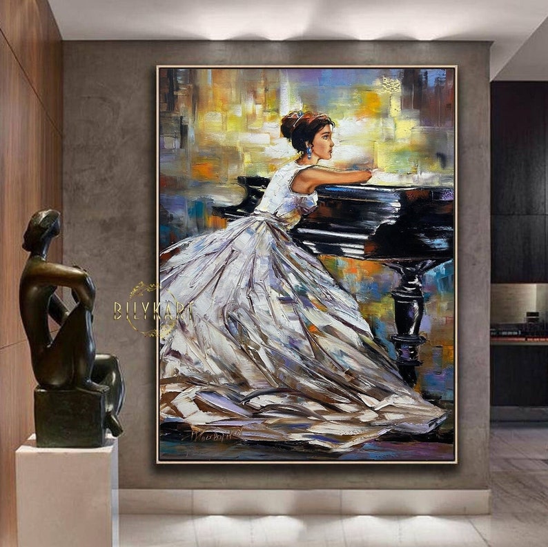 May include: An oil painting depicts a woman in a white gown leaning on a black piano. The artwork features a textured, impressionistic style with a palette of white, black, yellow, and blue. The painting is framed in a gold-colored border.