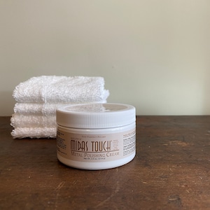May include: A white jar of Midas Touch Metal Polishing Cream. The jar is labeled with the product name and the words "The Premier Polish".