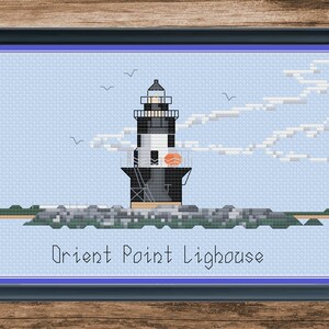 May include: A cross-stitch pattern of the Orient Point Lighthouse, a black and white lighthouse with a red roof, on a blue background with white clouds and birds.