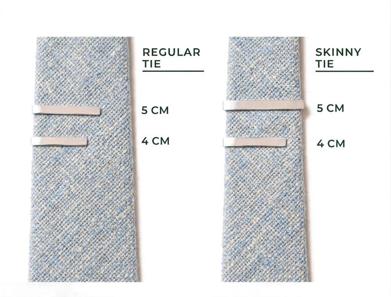 May include: Two light blue ties with silver tie bars. The text "REGULAR TIE" and "SKINNY TIE" are above the ties. Measurements are provided in centimeters: 5 cm and 4 cm.