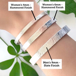 May include: Three silver bracelets with different widths and finishes. The bracelets are stacked on a person's wrist. The top bracelet is labeled "Women's 4mm - Hammered Finish", the middle bracelet is labeled "Women's 6mm - Hammered Finish", and the bottom bracelet is labeled "Men's 9mm - Slate Finish".