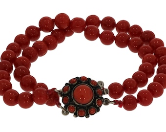 Deep red blood coral ball bracelet on beautiful silver rosette clasp.