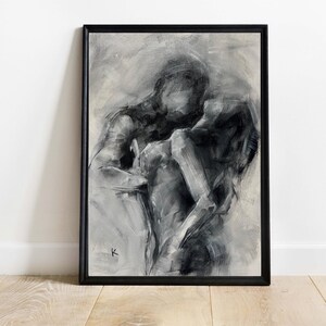 May include: Black framed abstract art print depicting two figures in an embrace. The artwork is rendered in grayscale with visible brushstrokes, creating a textured effect. The figures are indistinct, emphasizing the emotion of the moment.