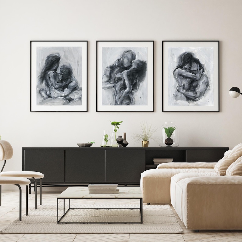 May include: Three framed wall art prints featuring charcoal-style sketches of figures in intimate embraces. Each piece uses monochromatic shades of black, white, and gray to depict abstract human forms in close contact against a light background.