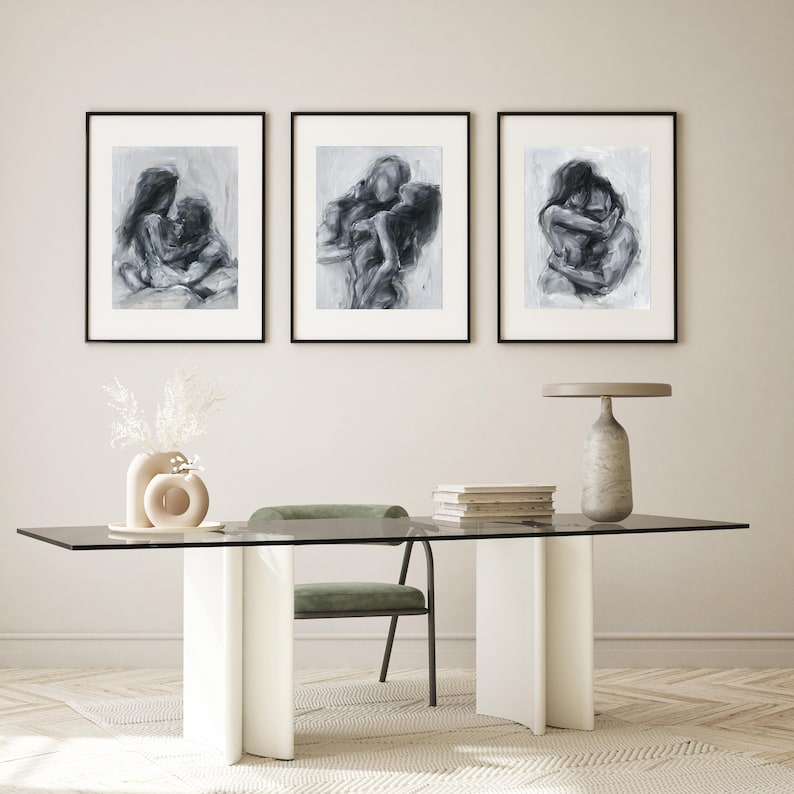 May include: Three framed wall art prints featuring charcoal-style sketches of couples in intimate embraces. Each piece displays expressive, gestural black and white figures on a light background, presented in thin black frames arranged horizontally.
