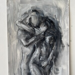 May include: Monochromatic oil painting on canvas depicting a tender embrace between two figures. The artwork, rendered in shades of gray, features expressive brushstrokes and a focus on form and emotion. The painting is mounted on a white surface.