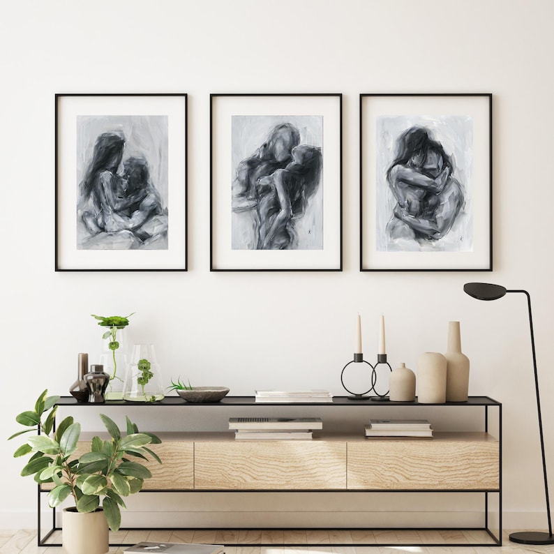 May include: Three framed wall art prints featuring charcoal-style sketches of intimate figures in various poses. Each piece is encased in a thin black frame, showcasing expressive, fluid brushstrokes in shades of gray, black, and white.