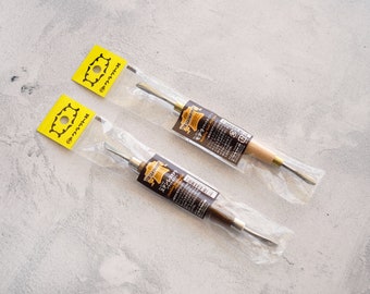 May include: Two leather working tools in individual clear plastic packaging with yellow labels that say "クラフト". The tools have wooden handles and metal blades.