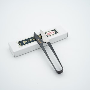 May include: Black embroidery scissors with a silver blade and a white box with Japanese text. The box is labeled "120mm".