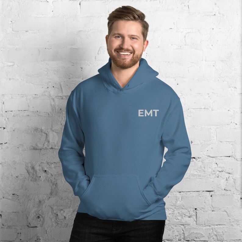 May include: A blue hooded sweatshirt with the word "EMT" embroidered on the front.