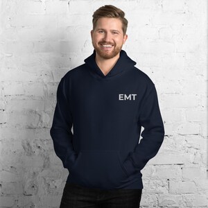 May include: A navy blue hoodie with a white embroidered "EMT" on the front.