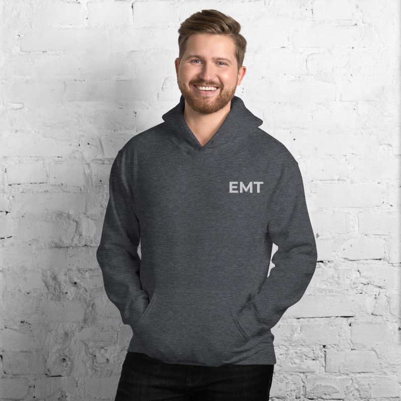 May include: A dark gray hooded sweatshirt with the word "EMT" embroidered on the left chest.